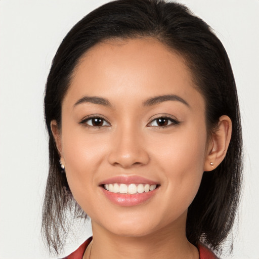 Joyful white young-adult female with long  brown hair and brown eyes