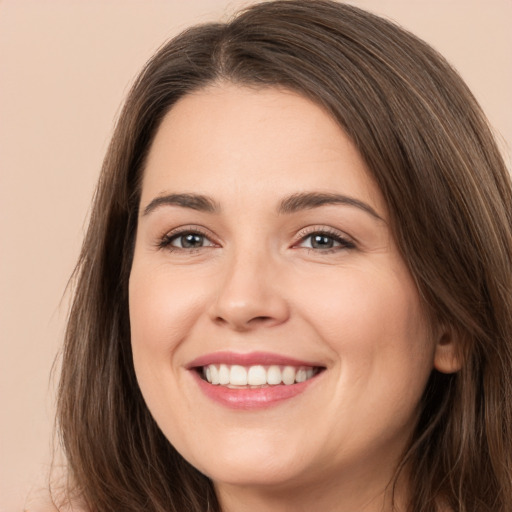 Joyful white young-adult female with long  brown hair and brown eyes