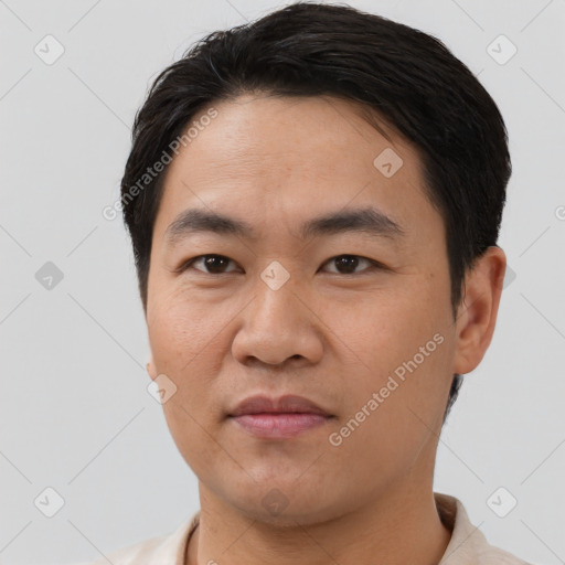 Joyful asian young-adult male with short  black hair and brown eyes