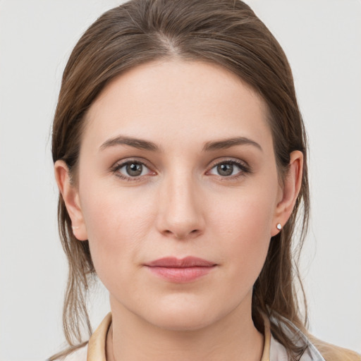 Joyful white young-adult female with medium  brown hair and grey eyes