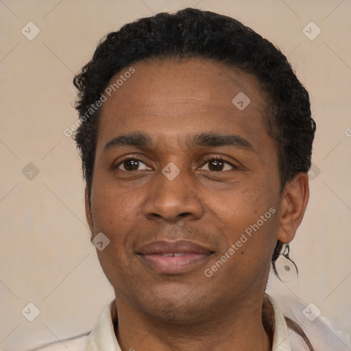 Joyful latino adult male with short  black hair and brown eyes