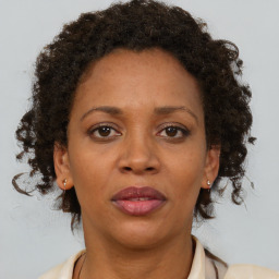 Joyful black adult female with short  brown hair and brown eyes