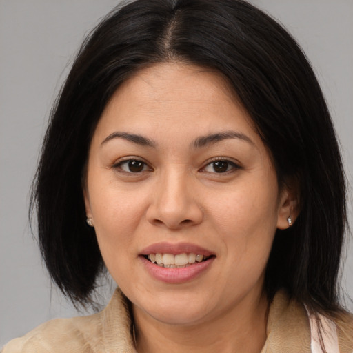 Joyful asian young-adult female with medium  brown hair and brown eyes