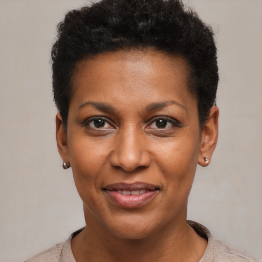 Joyful black young-adult female with short  black hair and brown eyes
