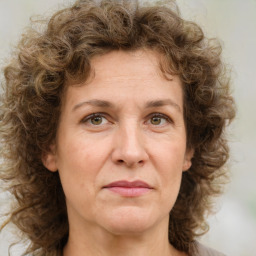 Joyful white adult female with medium  brown hair and green eyes