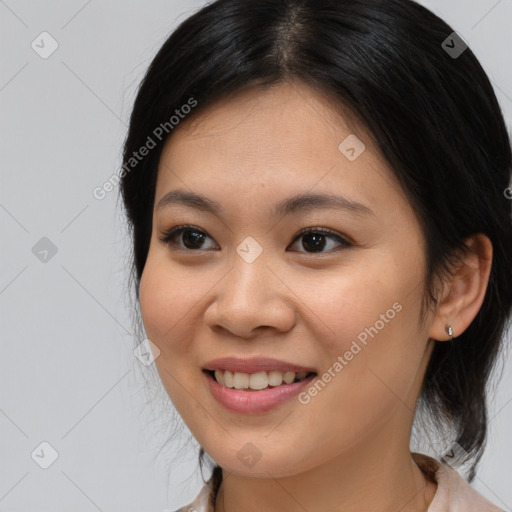 Joyful asian young-adult female with medium  brown hair and brown eyes