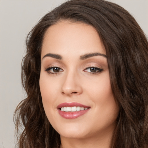 Joyful white young-adult female with long  brown hair and brown eyes