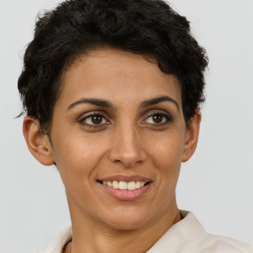 Joyful latino young-adult female with short  brown hair and brown eyes