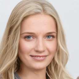 Joyful white young-adult female with long  brown hair and blue eyes