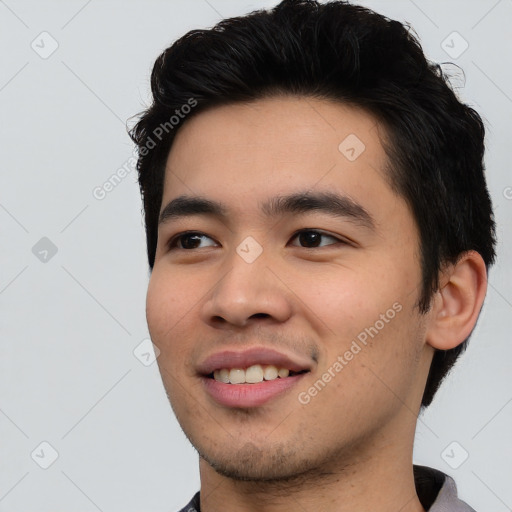 Joyful asian young-adult male with short  black hair and brown eyes