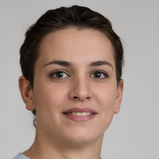 Joyful white young-adult female with short  brown hair and grey eyes