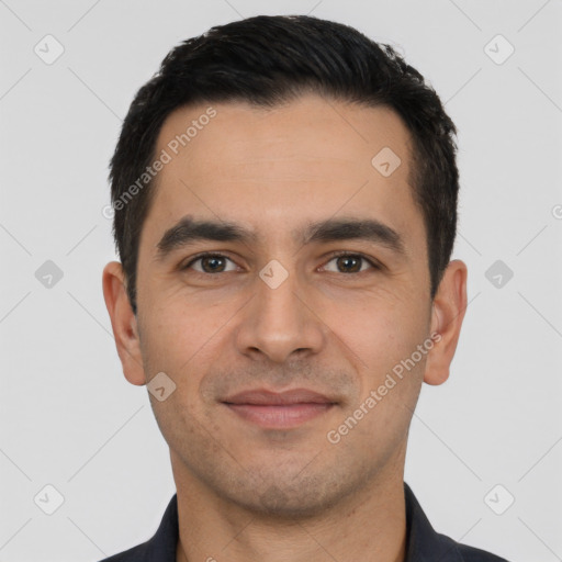 Joyful white young-adult male with short  black hair and brown eyes