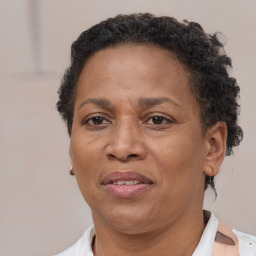 Joyful black adult female with short  brown hair and brown eyes