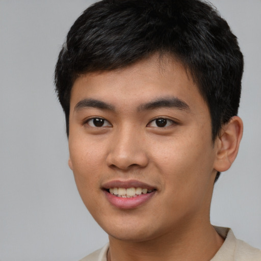 Joyful asian young-adult male with short  black hair and brown eyes