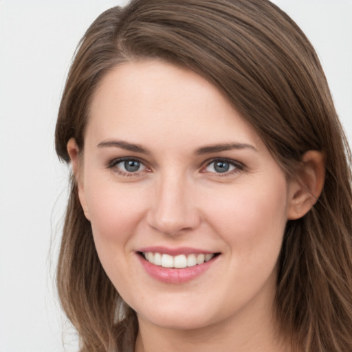 Joyful white young-adult female with long  brown hair and grey eyes