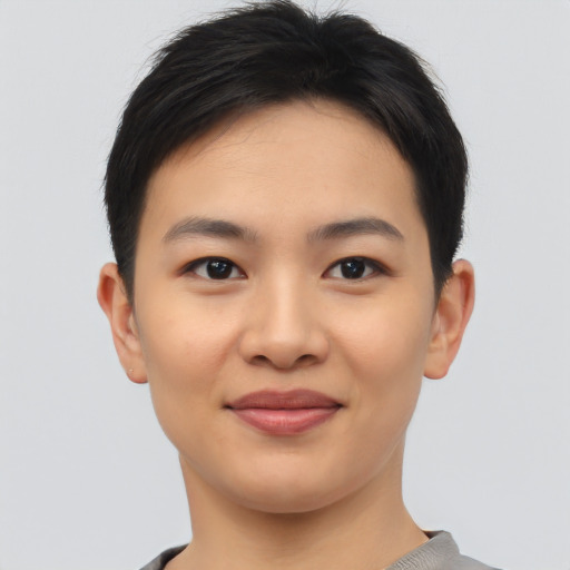 Joyful asian young-adult female with short  brown hair and brown eyes
