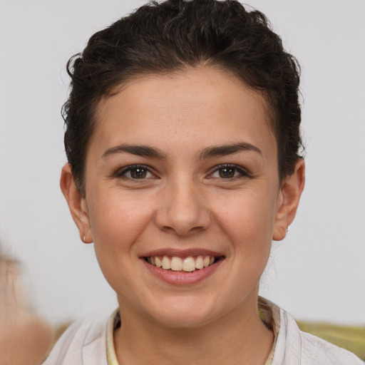 Joyful white young-adult female with short  brown hair and brown eyes