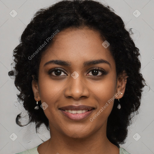 Joyful black young-adult female with long  black hair and brown eyes