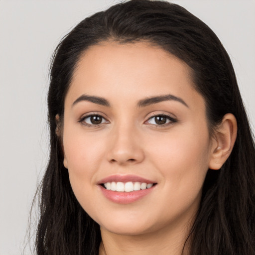 Joyful white young-adult female with long  black hair and brown eyes