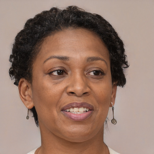 Joyful black adult female with short  brown hair and brown eyes