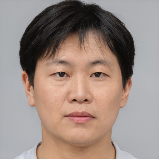 Neutral asian adult male with short  brown hair and brown eyes