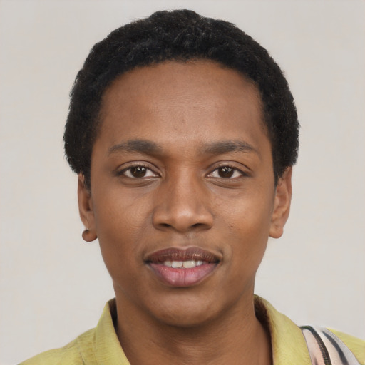 Joyful black young-adult male with short  black hair and brown eyes