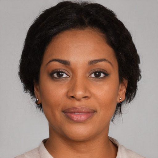 Joyful black young-adult female with medium  brown hair and brown eyes