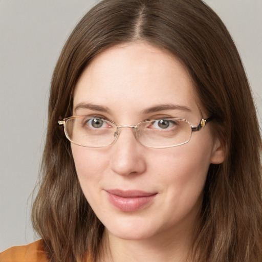 Joyful white young-adult female with long  brown hair and blue eyes