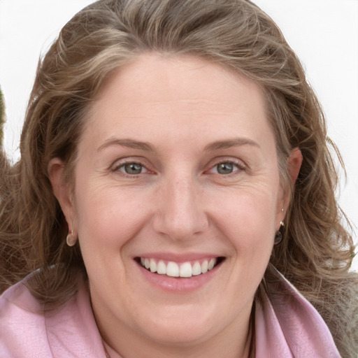 Joyful white young-adult female with long  brown hair and blue eyes