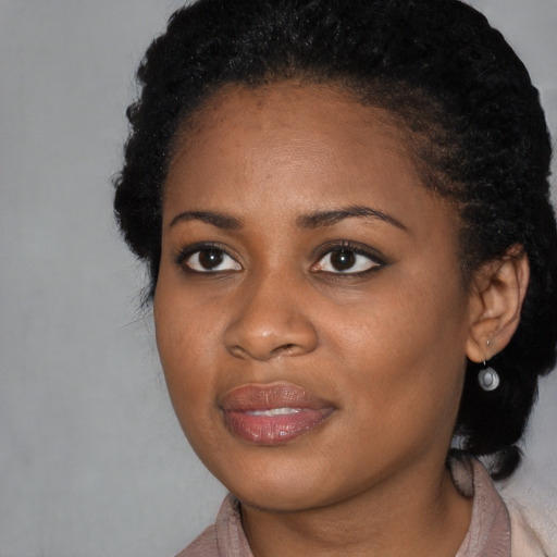 Joyful black young-adult female with medium  brown hair and brown eyes