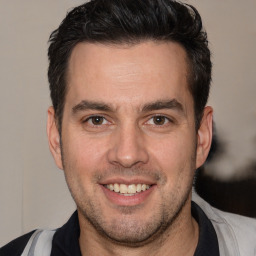 Joyful white adult male with short  brown hair and brown eyes