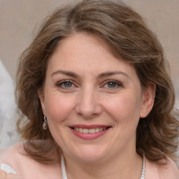 Joyful white adult female with medium  brown hair and brown eyes