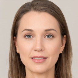 Joyful white young-adult female with long  brown hair and grey eyes