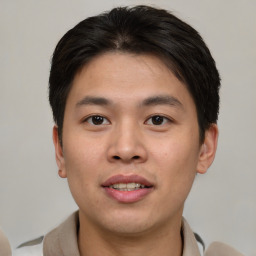 Joyful asian young-adult male with short  brown hair and brown eyes