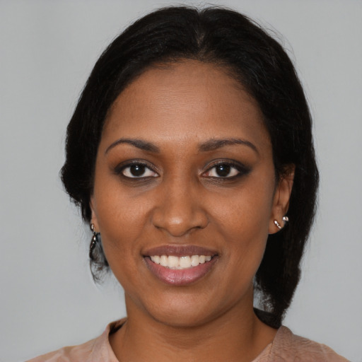 Joyful black young-adult female with medium  black hair and brown eyes