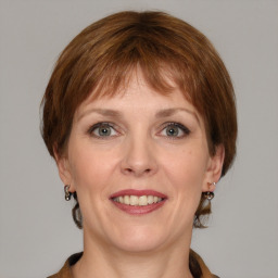 Joyful white young-adult female with medium  brown hair and blue eyes