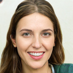 Joyful white young-adult female with long  brown hair and green eyes