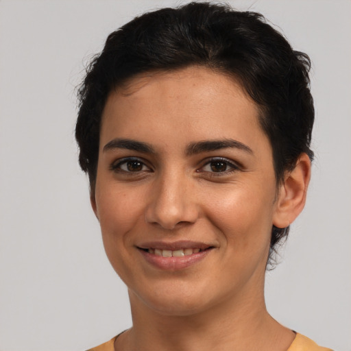 Joyful latino young-adult female with short  black hair and brown eyes