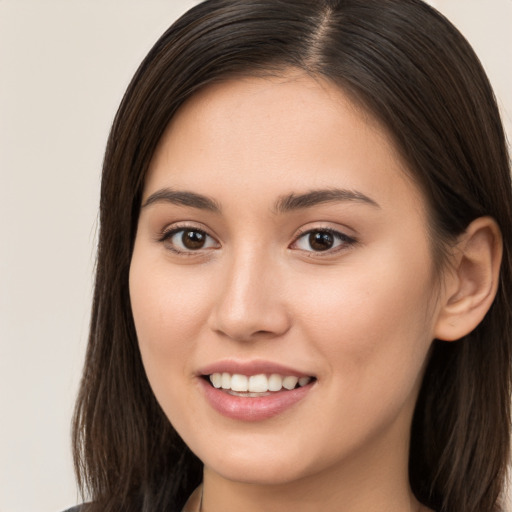 Joyful white young-adult female with long  brown hair and brown eyes