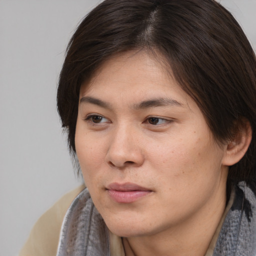 Joyful asian young-adult female with medium  brown hair and brown eyes