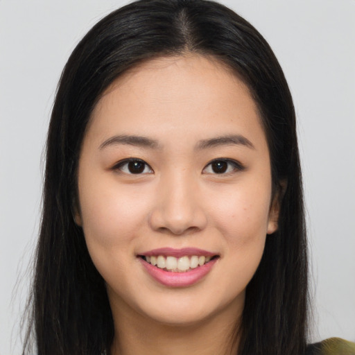 Joyful asian young-adult female with long  brown hair and brown eyes