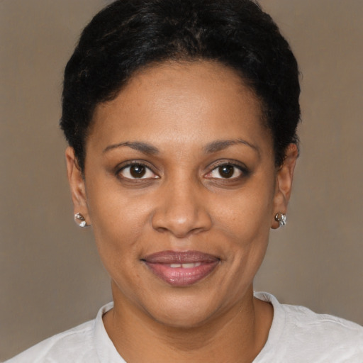 Joyful black young-adult female with short  black hair and brown eyes