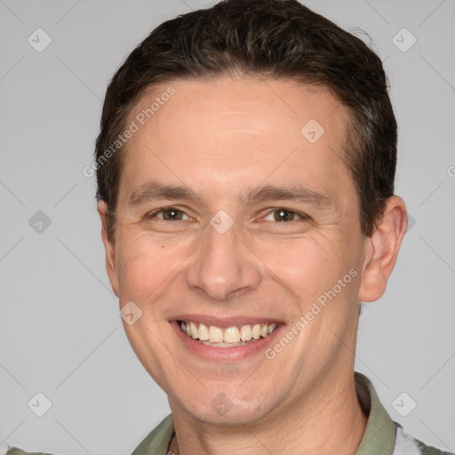 Joyful white adult male with short  brown hair and grey eyes