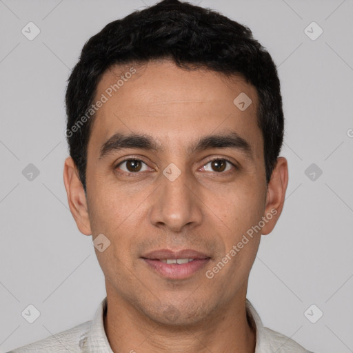 Joyful white young-adult male with short  black hair and brown eyes