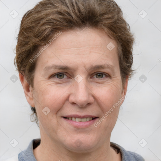 Joyful white adult female with short  brown hair and grey eyes