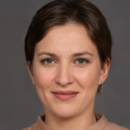 Joyful white adult female with medium  brown hair and grey eyes