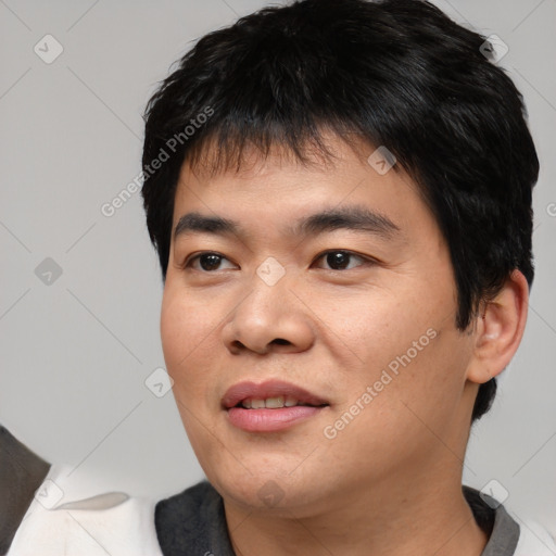 Joyful asian young-adult male with short  black hair and brown eyes
