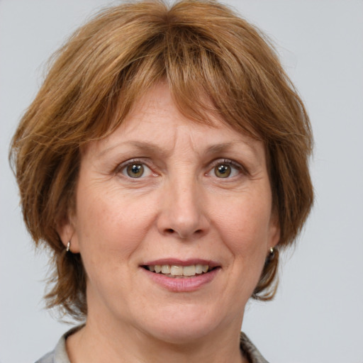 Joyful white adult female with medium  brown hair and grey eyes