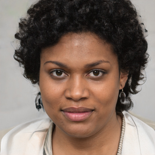 Joyful black young-adult female with medium  brown hair and brown eyes