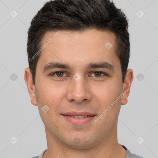 Joyful white young-adult male with short  brown hair and brown eyes